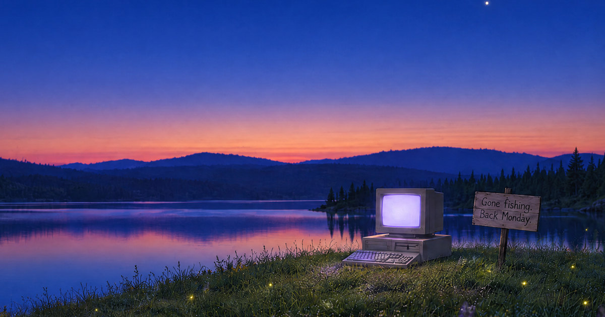 The lake at blue hour, a thin band of orange on the horizon, the old computer lit on the grass beside the sign.